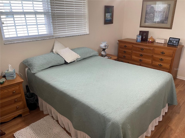 bedroom with wood-type flooring