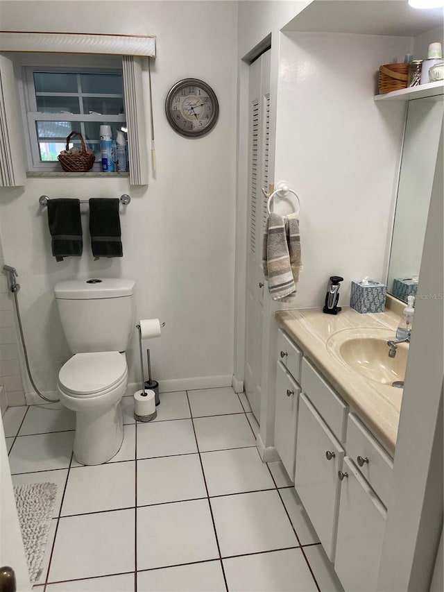 bathroom featuring vanity, toilet, and tile patterned floors