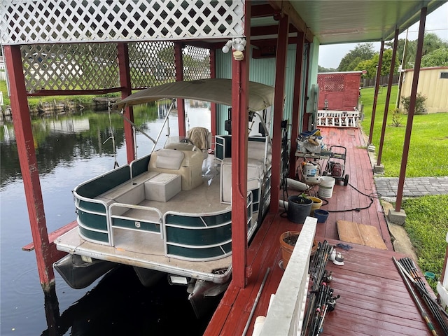 dock area with a lawn and a water view