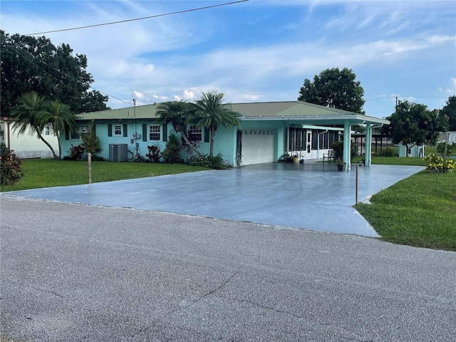 single story home featuring a garage, cooling unit, and a front lawn