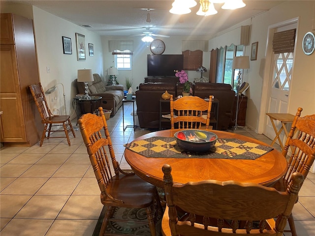 tiled dining space featuring ceiling fan and a textured ceiling