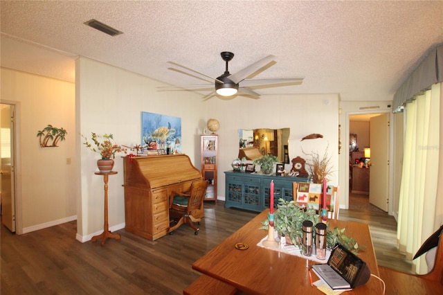 interior space featuring dark wood-type flooring, a textured ceiling, and ceiling fan