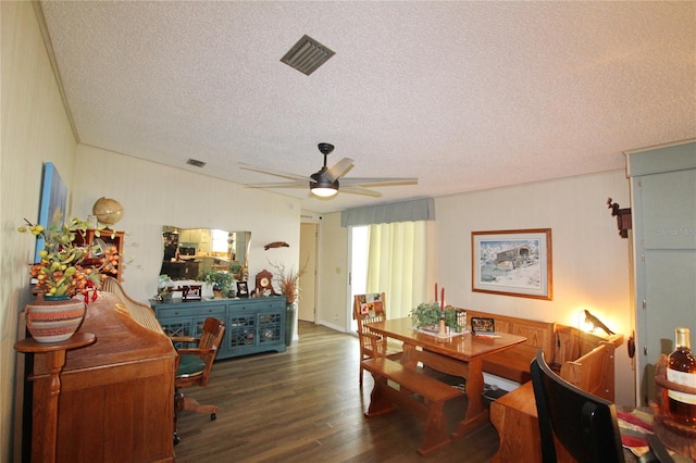 dining area featuring a textured ceiling, ceiling fan, and dark hardwood / wood-style floors