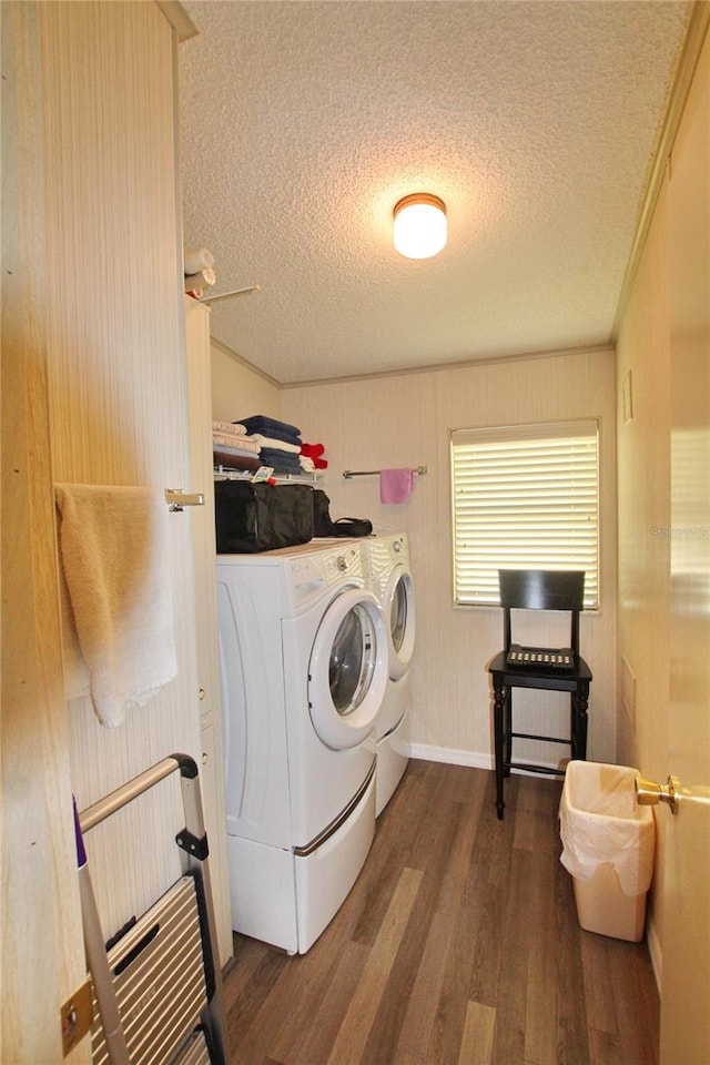 laundry area featuring dark hardwood / wood-style flooring, washer and clothes dryer, and a textured ceiling