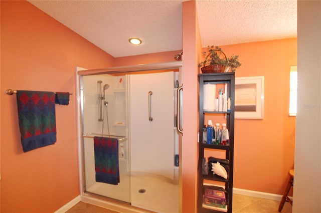 bathroom with walk in shower and a textured ceiling