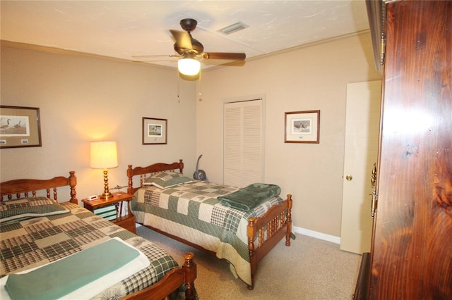 carpeted bedroom featuring ceiling fan and a closet