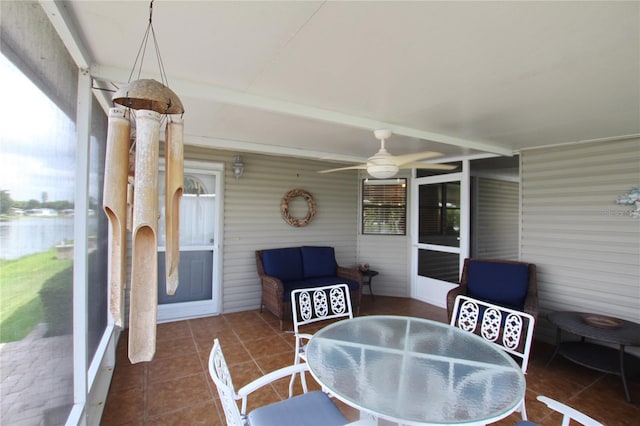 sunroom featuring ceiling fan