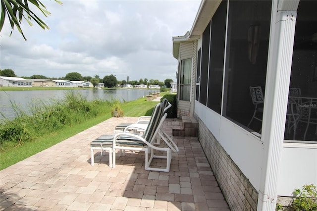 view of patio with a water view