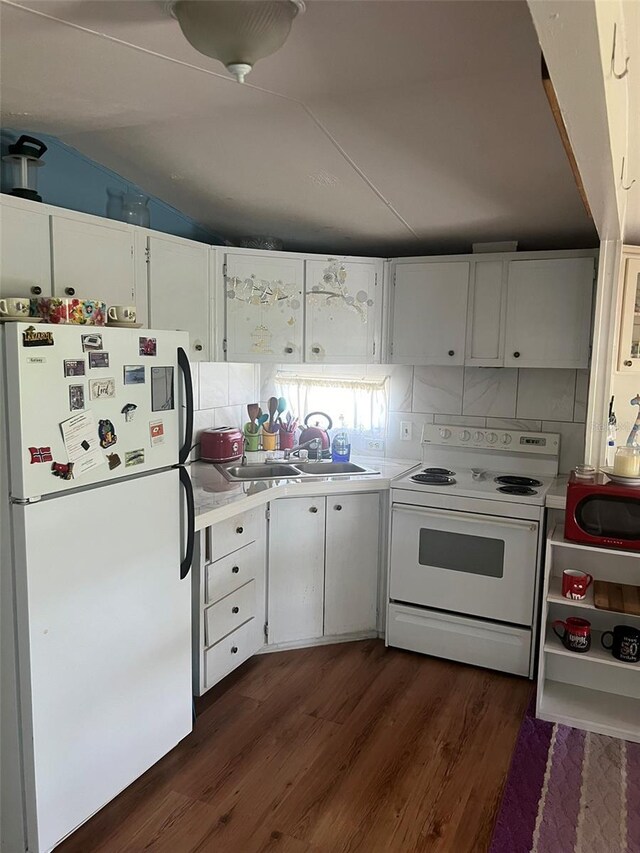 kitchen with dark hardwood / wood-style floors, white appliances, sink, white cabinetry, and lofted ceiling