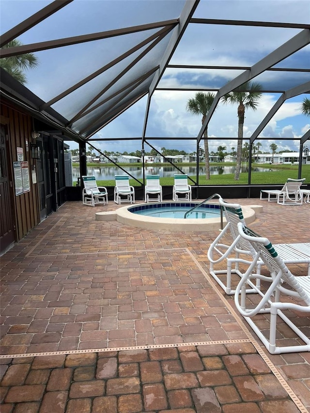 6697 SE 51st Ln Iii, Unit Iii, Okeechobee, FL 34974 - view of swimming pool featuring a pool, glass enclosure, a community hot tub, and a patio area