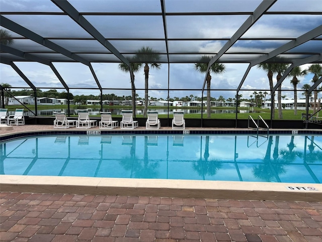 view of pool featuring glass enclosure