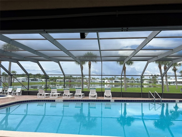 6697 SE 51st Ln Iii, Unit Iii, Okeechobee, FL 34974 - pool featuring a patio, a water view, and glass enclosure