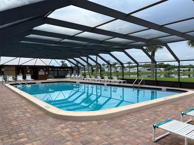 6697 SE 51st Ln Iii, Unit Iii, Okeechobee, FL 34974 - community pool featuring a water view, glass enclosure, and a patio area