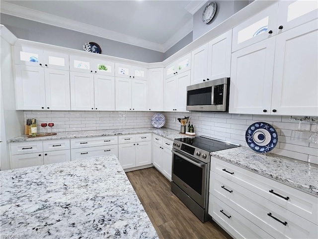 kitchen featuring white cabinets, light stone countertops, stainless steel appliances, dark wood-type flooring, and ornamental molding