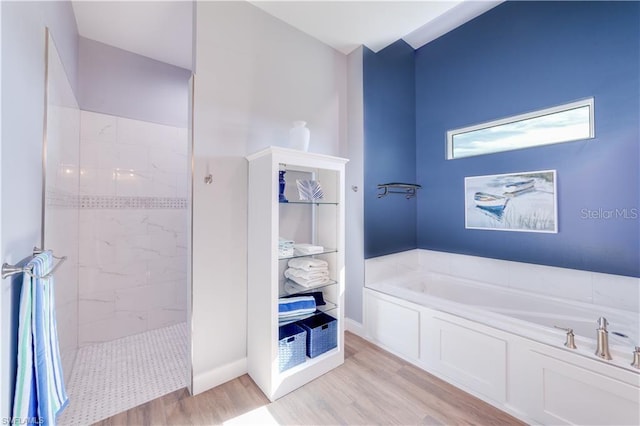 bathroom with independent shower and bath and wood-type flooring