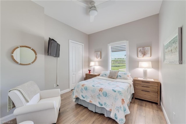 bedroom featuring ceiling fan, a closet, and light hardwood / wood-style floors