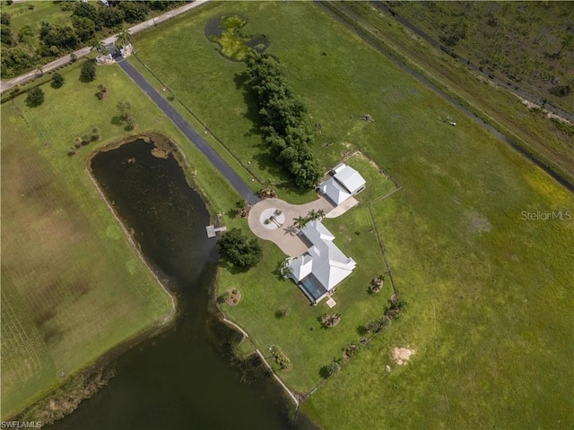 birds eye view of property with a water view and a rural view