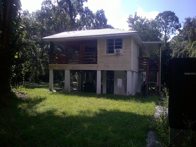 back of property featuring a yard and a deck