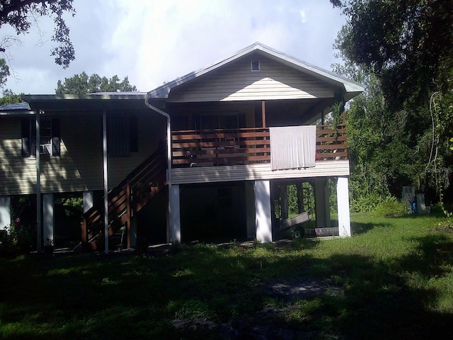 rear view of property with a lawn