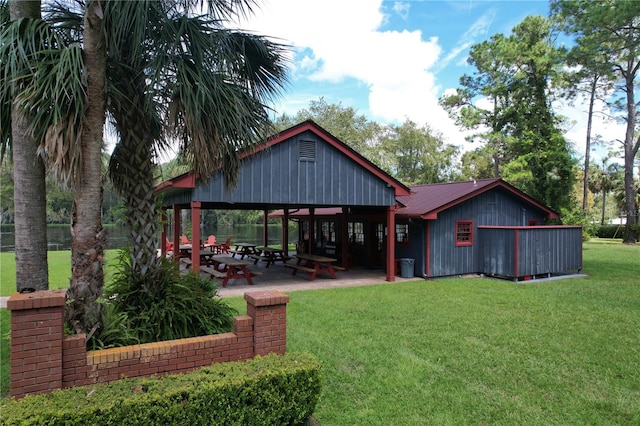 rear view of property featuring a lawn, a gazebo, and a patio area