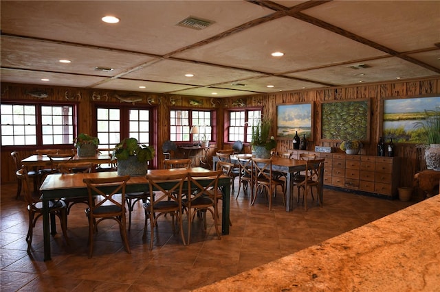 dining space featuring wood walls and a healthy amount of sunlight