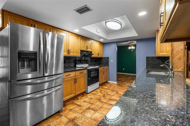 kitchen featuring sink, stainless steel fridge with ice dispenser, backsplash, white range with electric cooktop, and a tray ceiling