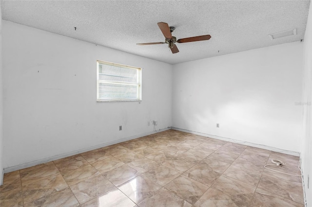 spare room with ceiling fan and a textured ceiling