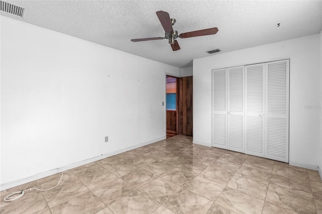 unfurnished bedroom featuring ceiling fan, a closet, and a textured ceiling