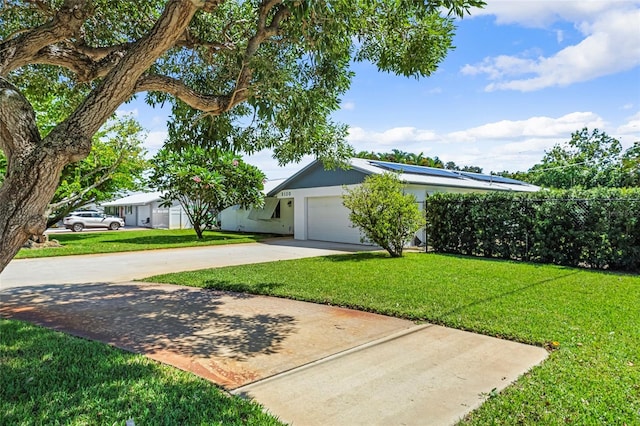 ranch-style home featuring a garage and a front lawn