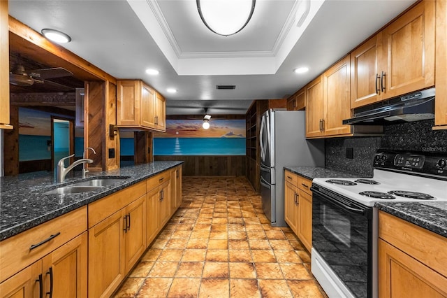 kitchen with white electric range, sink, dark stone countertops, tasteful backsplash, and a tray ceiling