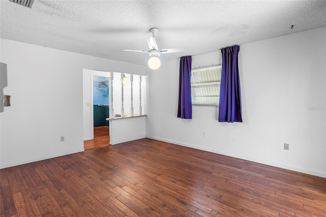 empty room with a textured ceiling, ceiling fan, and dark wood-type flooring