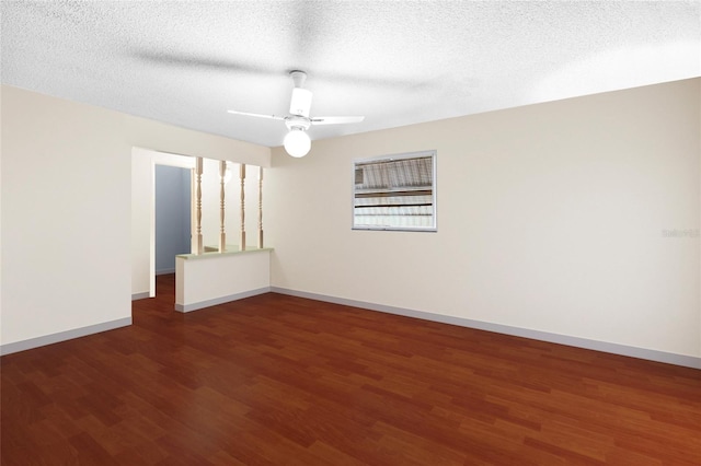 unfurnished room with ceiling fan, dark wood-type flooring, and a textured ceiling