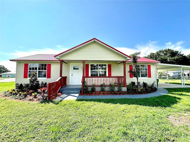 single story home with a front lawn, a carport, and covered porch