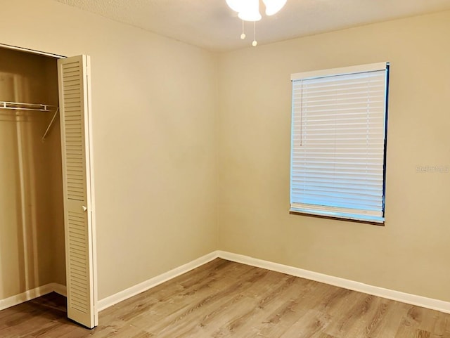 unfurnished bedroom featuring wood-type flooring and a closet