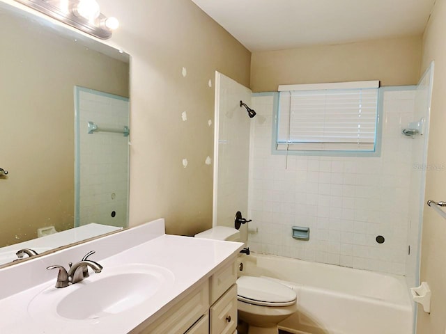 full bathroom featuring vanity, tiled shower / bath combo, and toilet