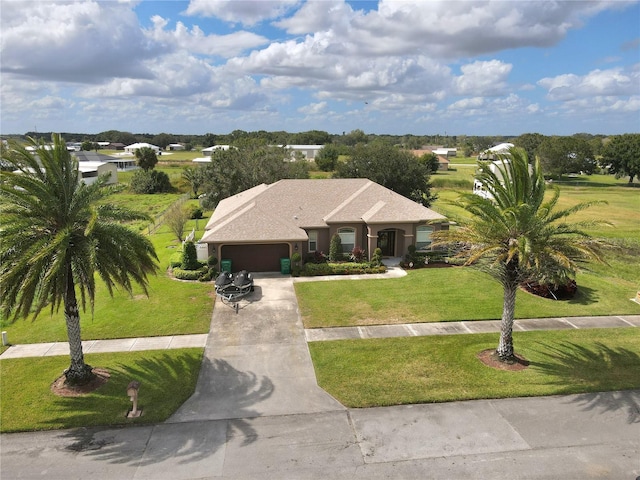 view of front of property with a front lawn and a garage