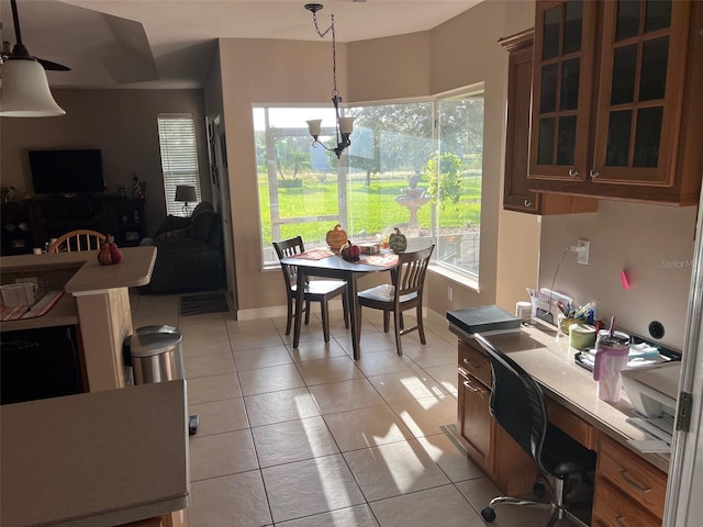 tiled dining space with a healthy amount of sunlight