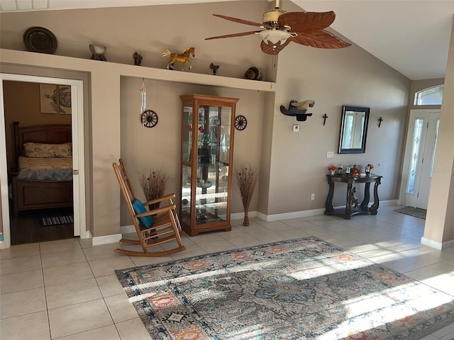 unfurnished living room with ceiling fan, high vaulted ceiling, and light tile patterned floors