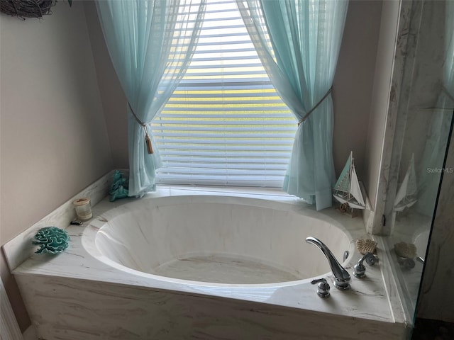 bathroom with tiled tub