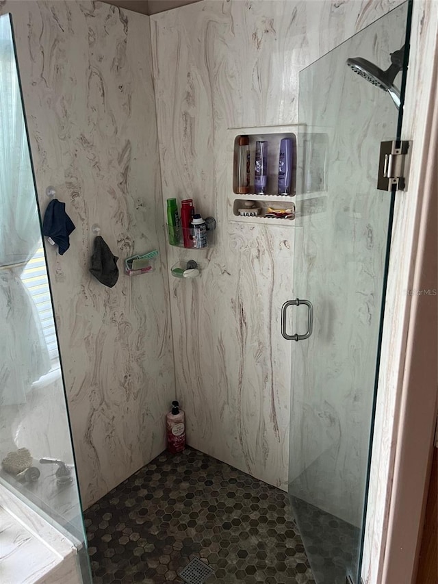 bathroom with a shower with shower door