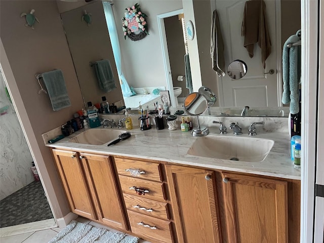 bathroom with toilet, a shower, vanity, and tile patterned floors