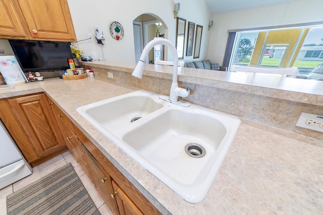 interior details featuring sink and light tile patterned floors