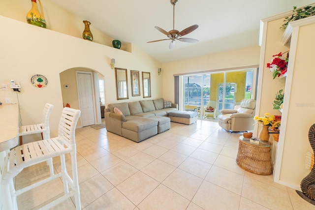 tiled living room featuring lofted ceiling and ceiling fan