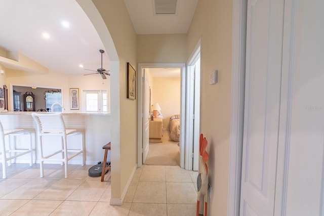 hall featuring light tile patterned floors