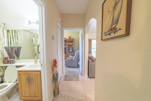 corridor with sink and light tile patterned floors