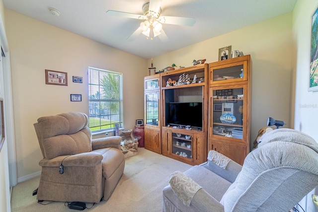 carpeted living room featuring ceiling fan