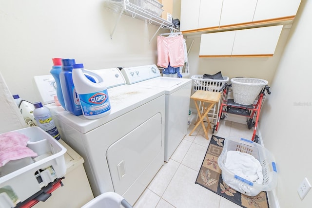 laundry room featuring washing machine and dryer and light tile patterned floors