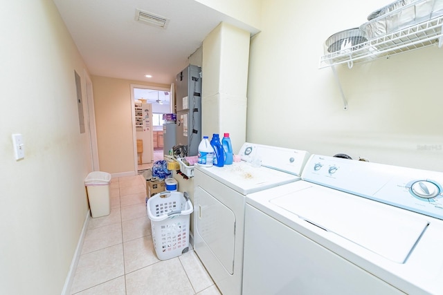 laundry room with separate washer and dryer and light tile patterned floors