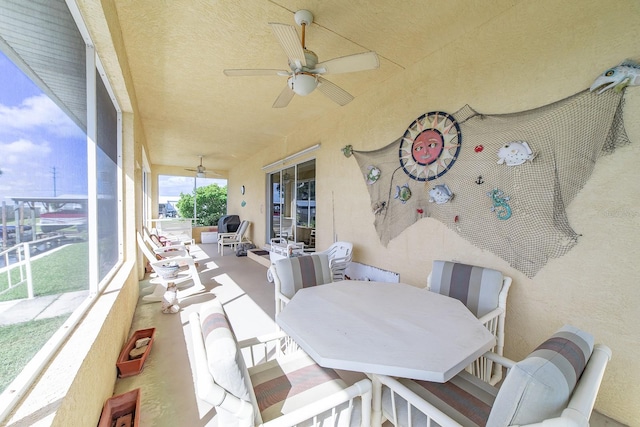 sunroom featuring ceiling fan