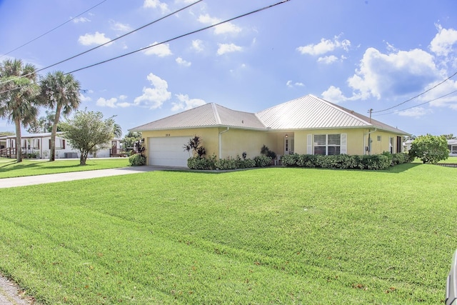 view of front of property with a front yard and a garage